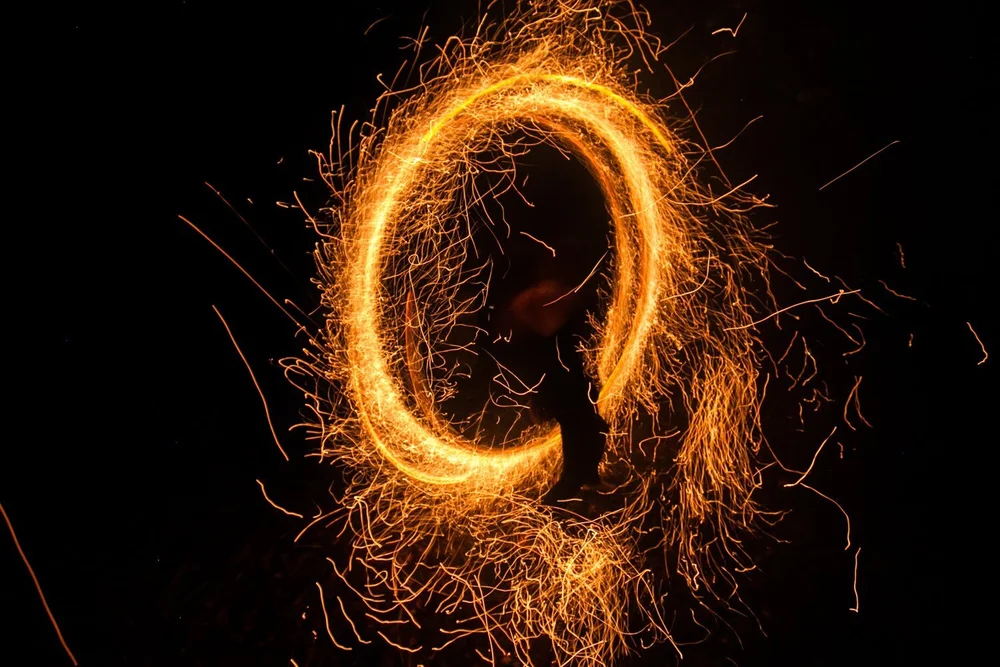 A spinning ring of sparks at night