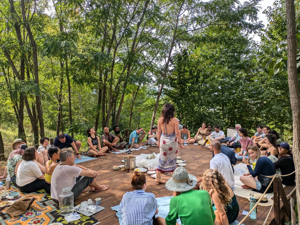 Participants sitting in a circle on the grass
