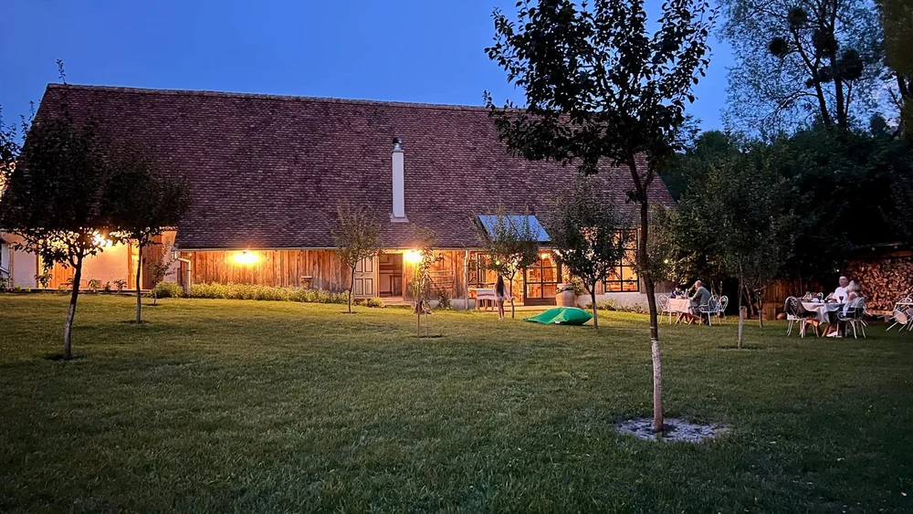 A farmhouse and its courtyard at golden hour